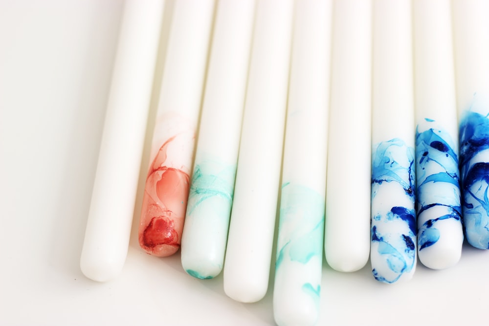 several white, blue, and red decorative taper candles