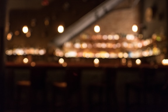 A warm, inviting image of a cozy lounge with soft lighting, suggesting a discreet and comfortable atmosphere.