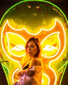 Backstage moment with Bigg Britt smiling, neon lights casting a cool glow on her face.