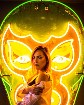 Backstage moment with Bigg Britt smiling, neon lights casting a cool glow on her face.