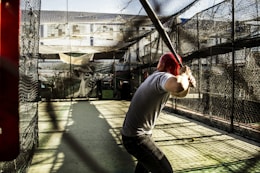 person holding baseball bat waiting for pitch