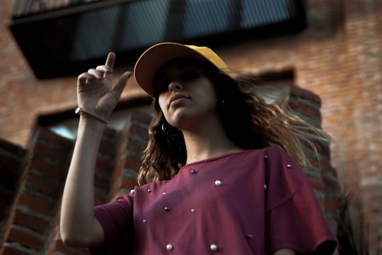 low angle of woman standing near brick building in Guadalajara Mexico