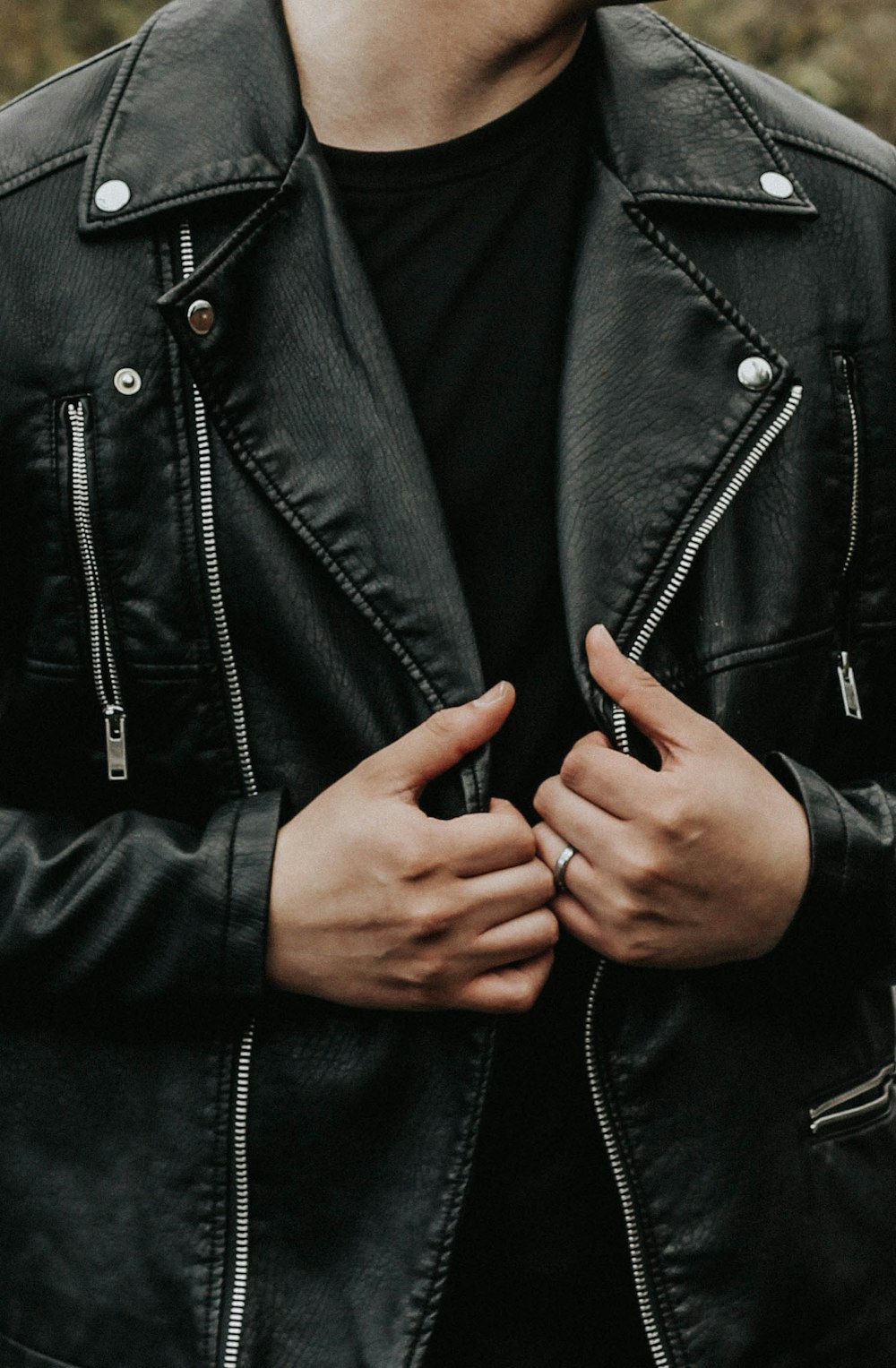 man holding his leather jacket