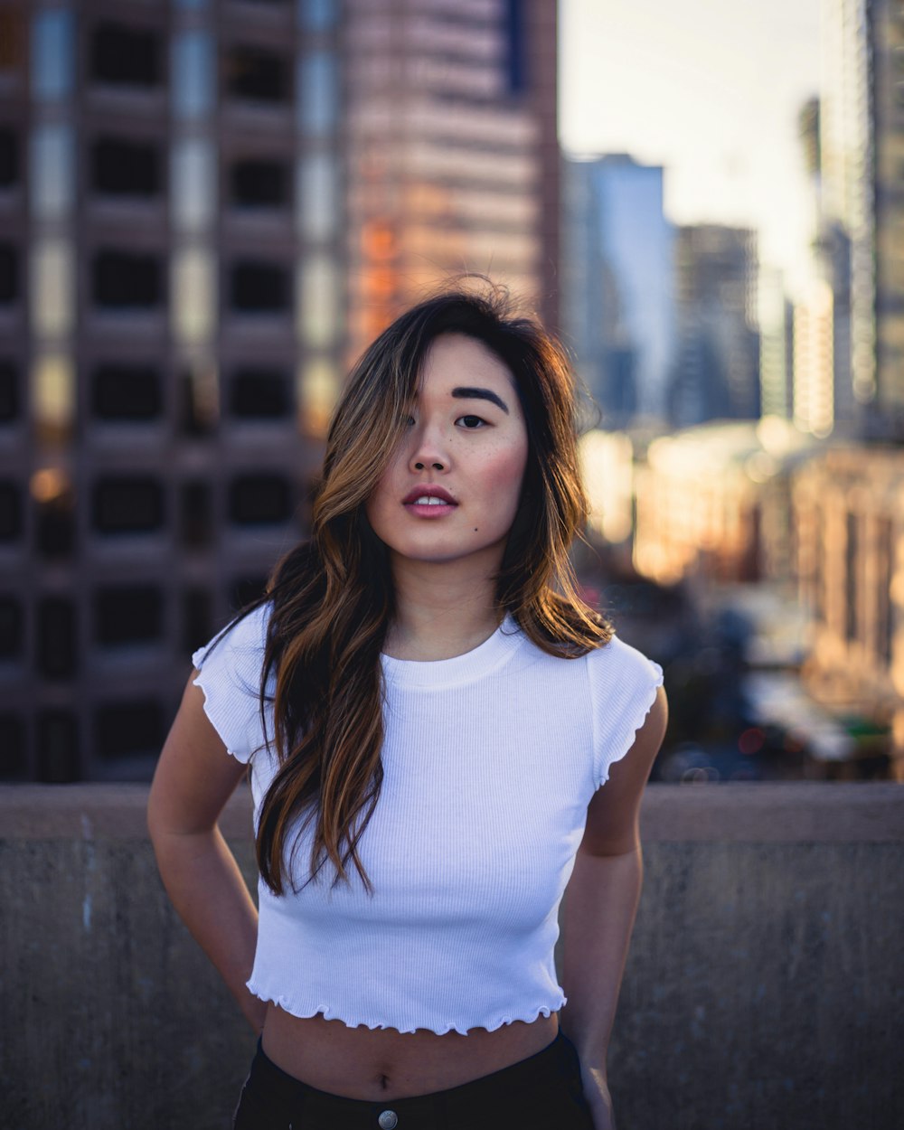 woman posing near wall during daytimne