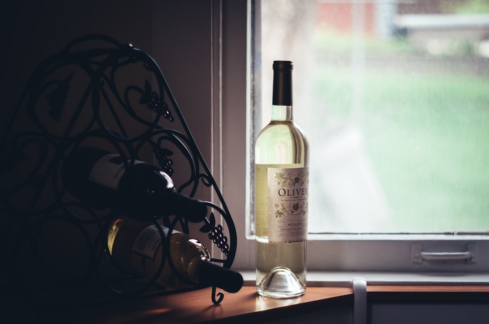 clear glass bottle near window