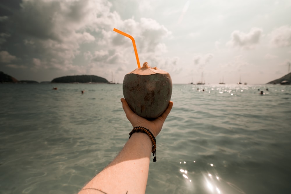 person holding coconut juice