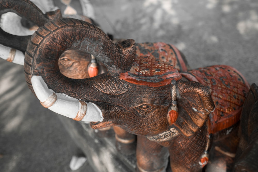 two brown elephant ceramic figurines