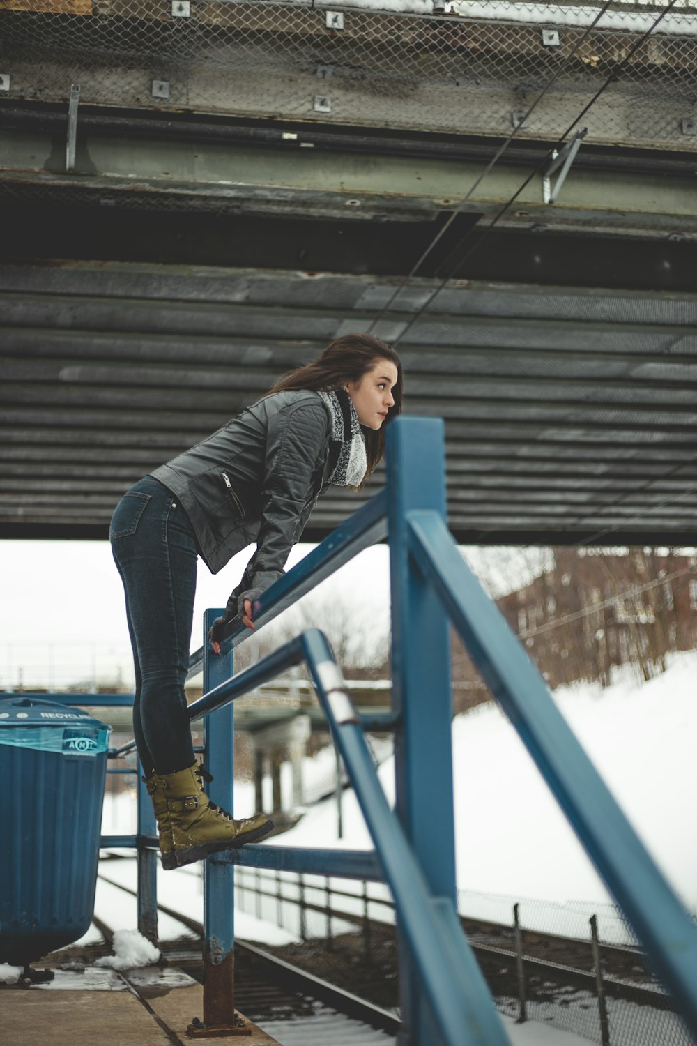 woman standing on blue rails