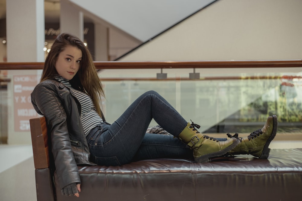 woman sitting on a leather padded sofa