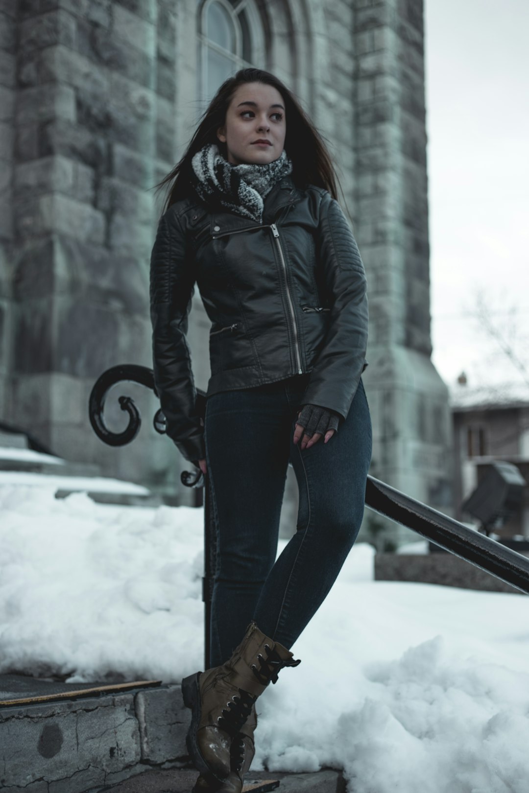 woman leaning on black metal railing during daytime