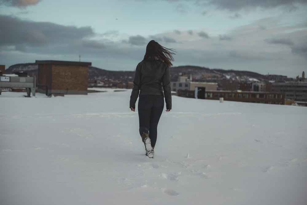 woman walking through brown building