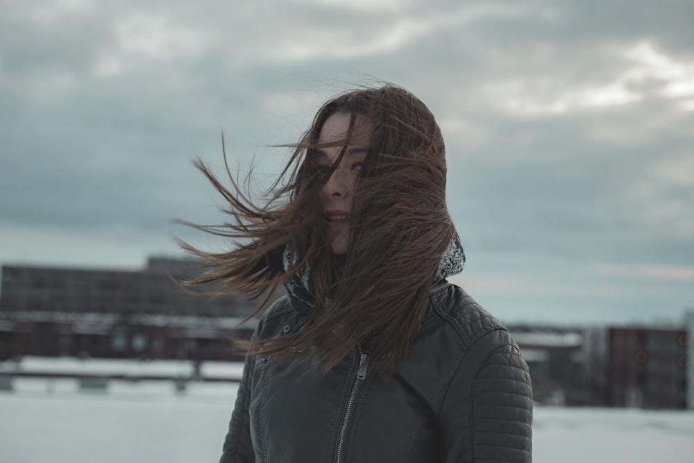 mujer de pie mientras el cabello es arrastrado por el viento