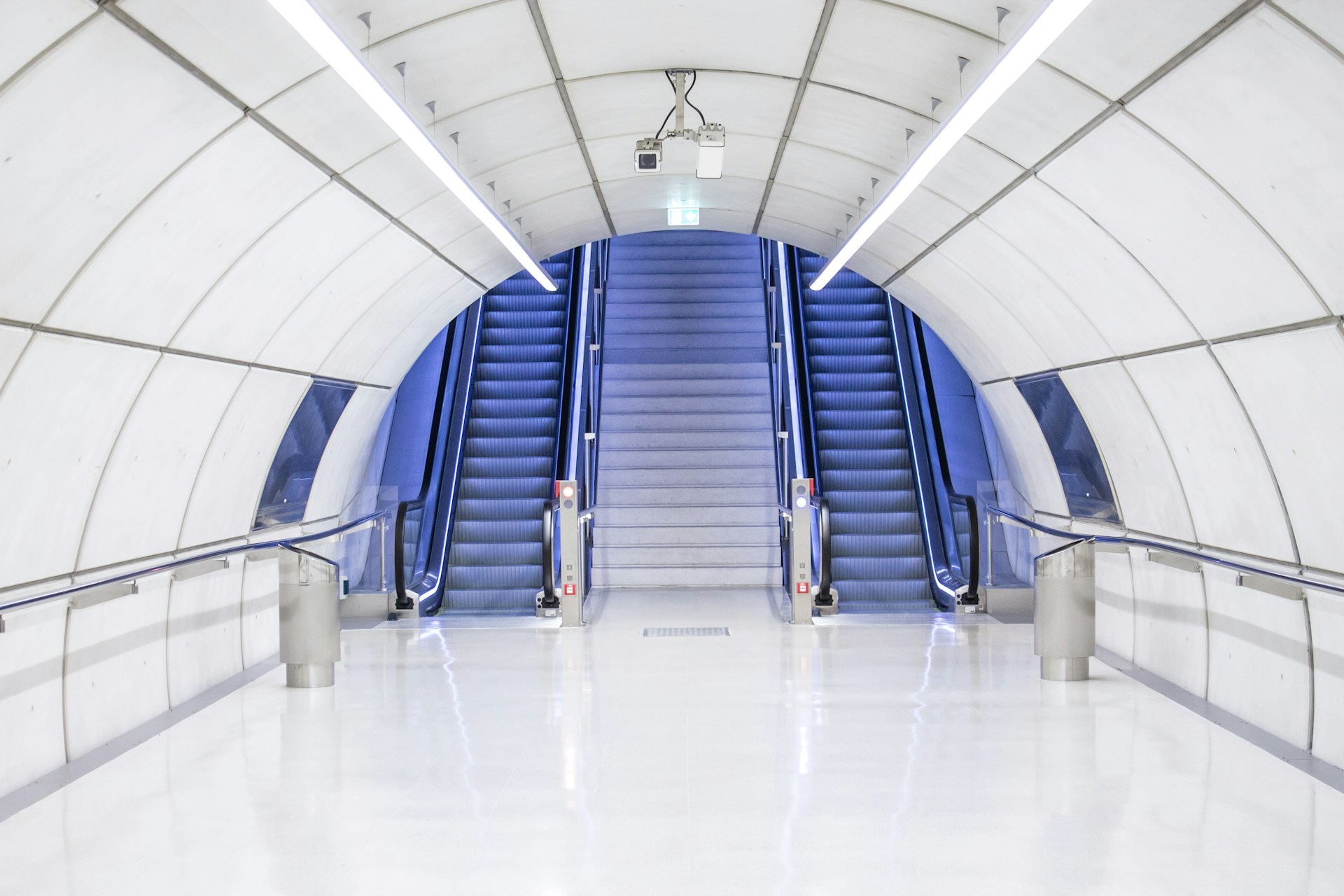 gray concrete arch hallway near escalator