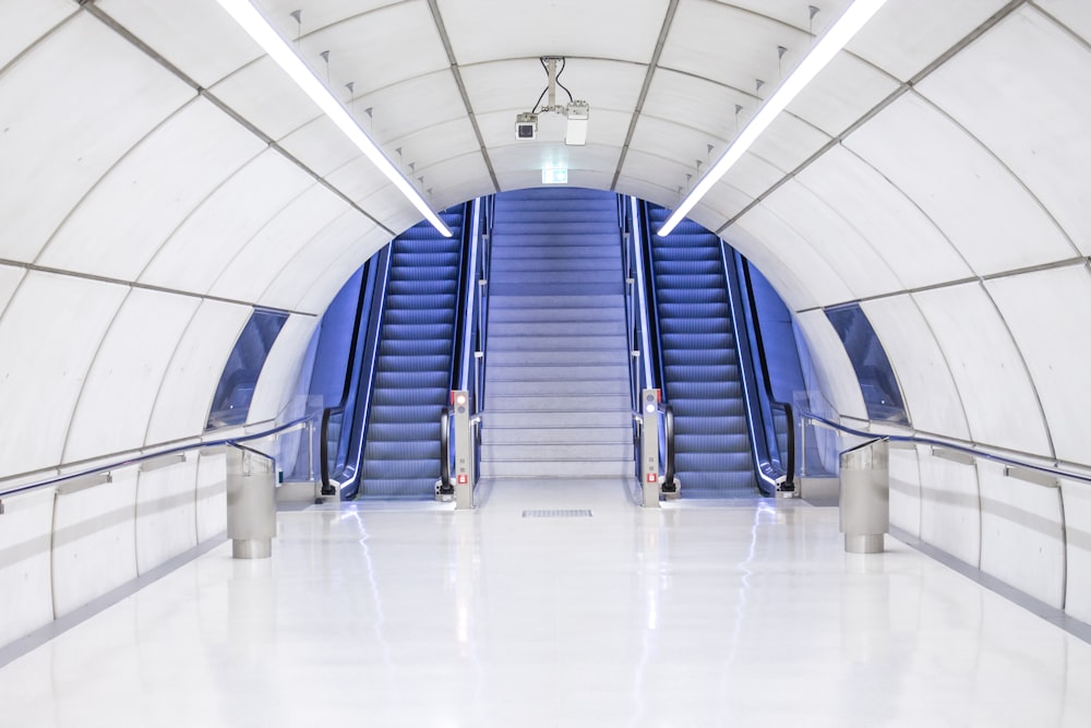 gray concrete arch hallway near escalator