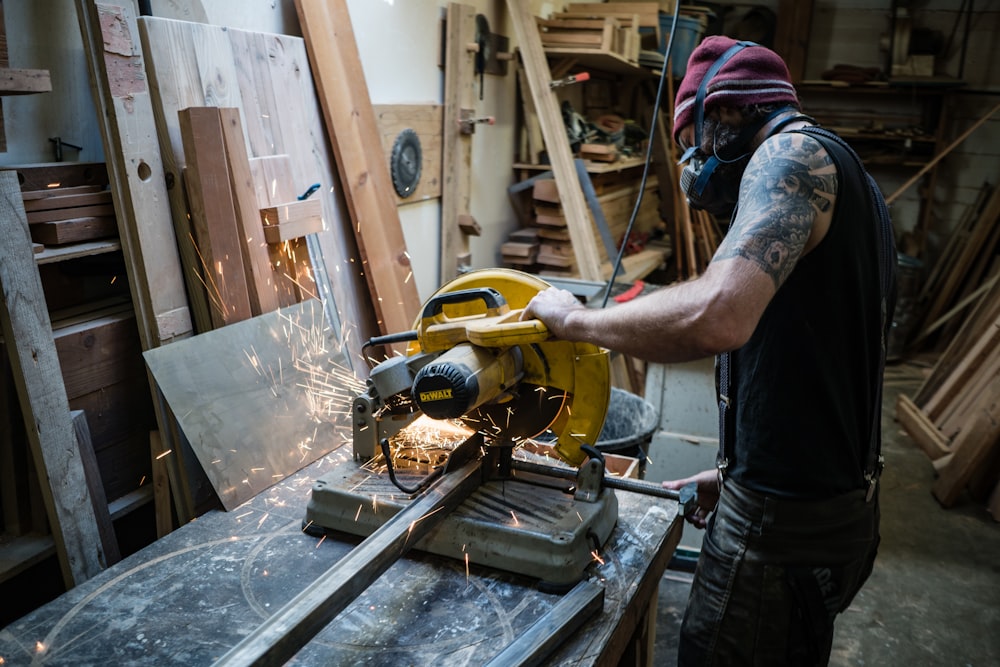 man using cut off saw