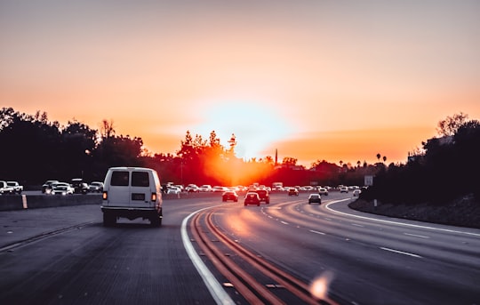 white van on grey concrete road during golden hour in California United States
