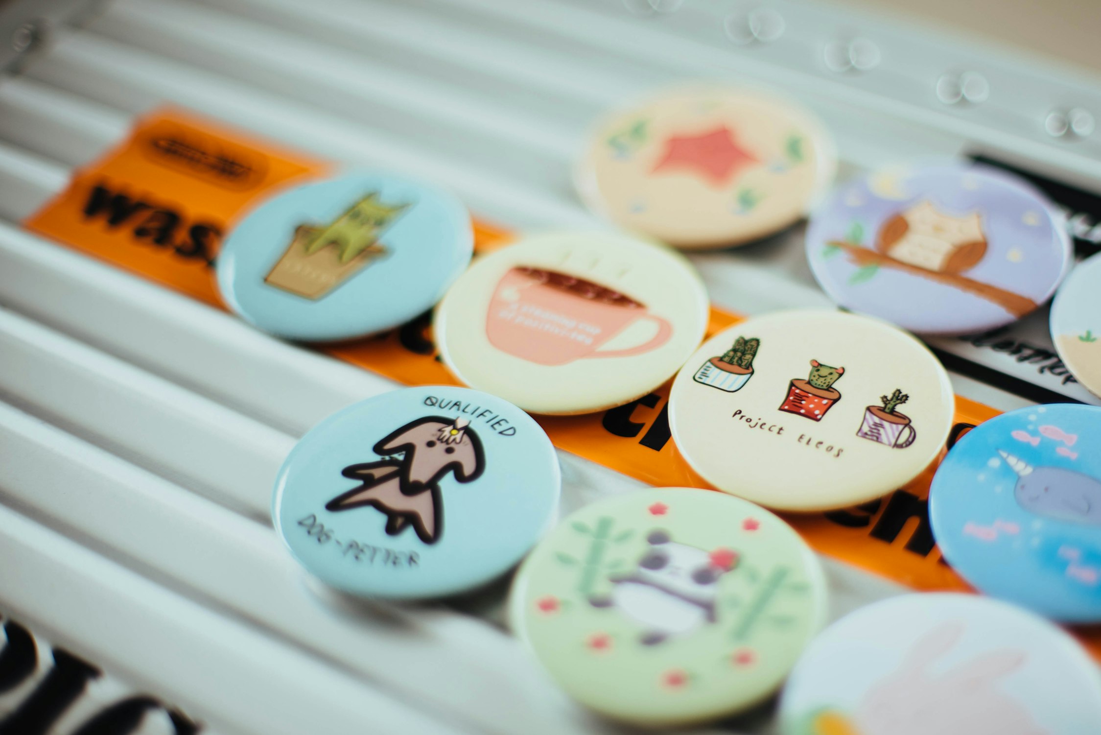 Assorted badges, including one stating Qualified Dog-Petter