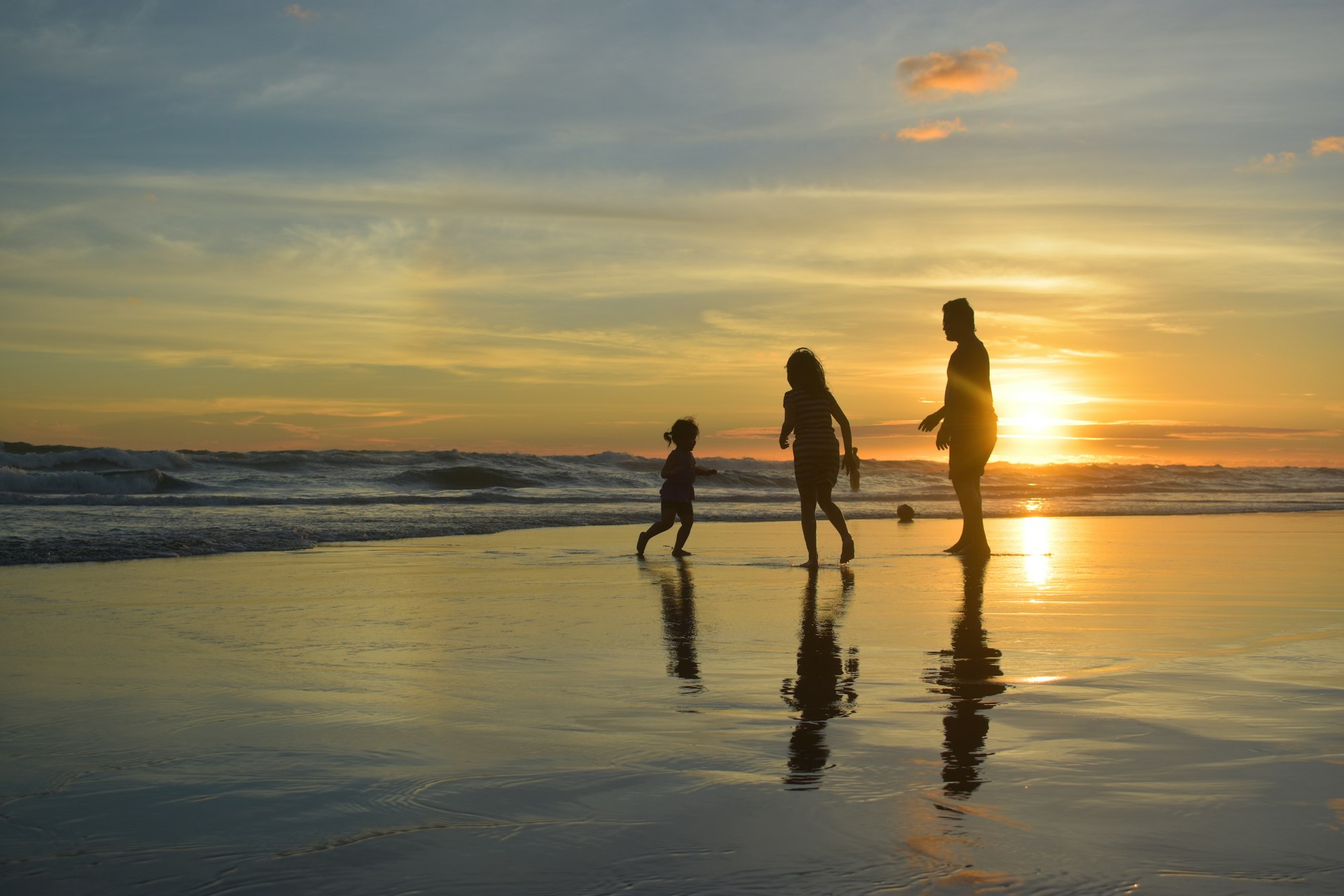 A family enjoying sunset by the shore