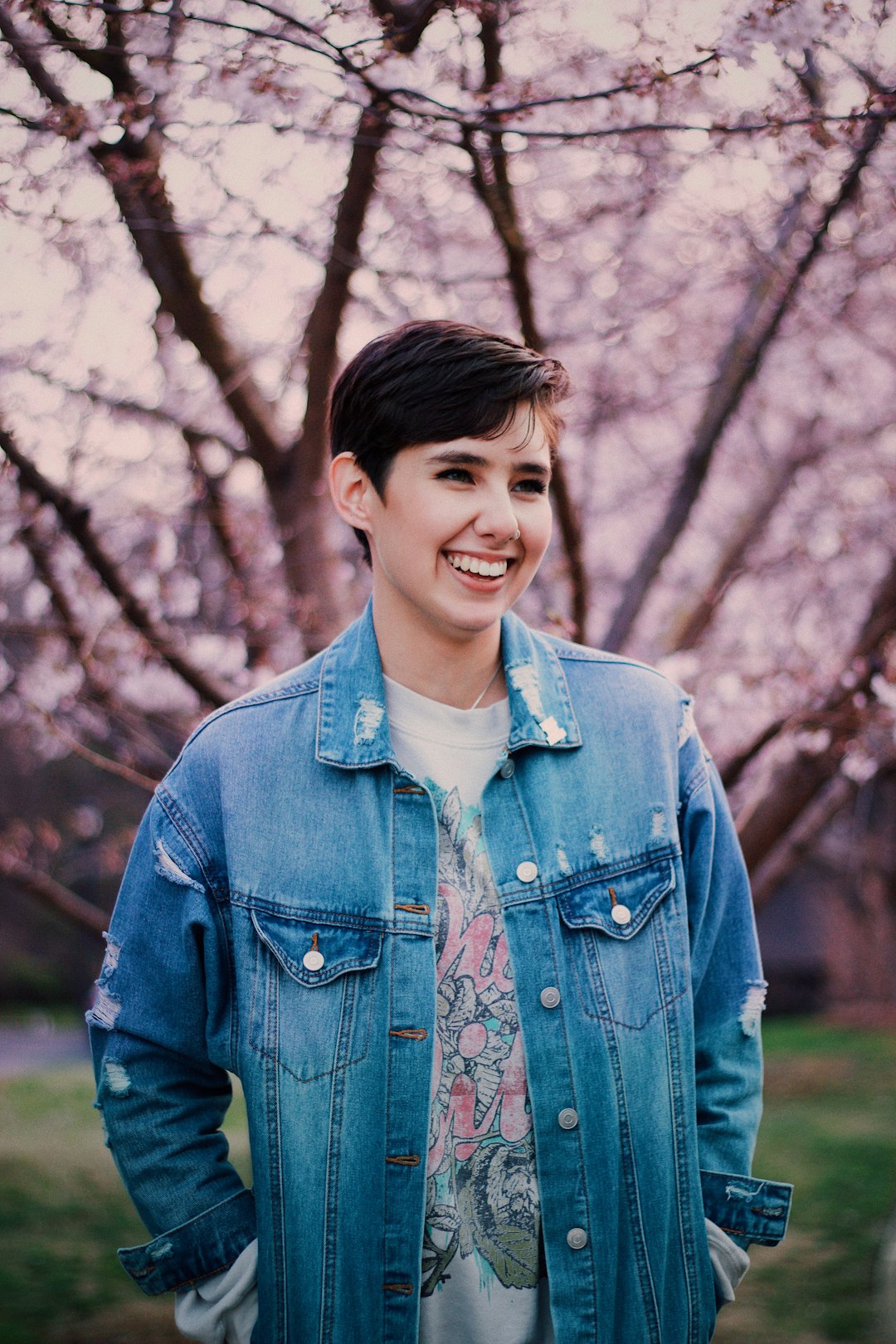 woman in blue denim jacket smiling