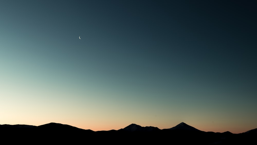 silhouette photo of mountain peaks