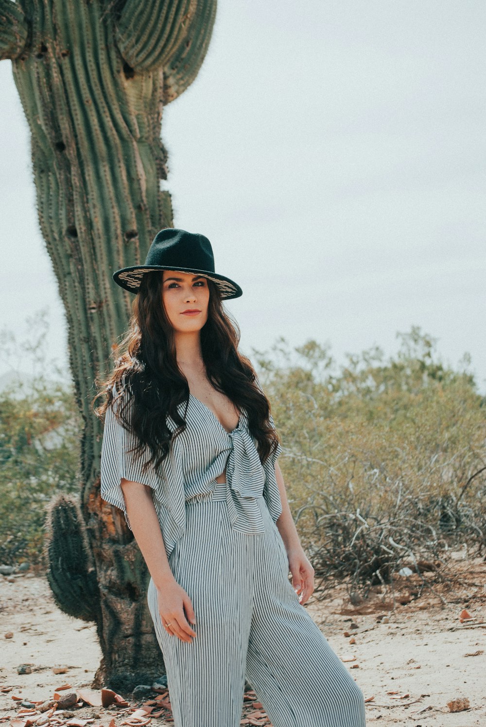 woman standing behind cactus