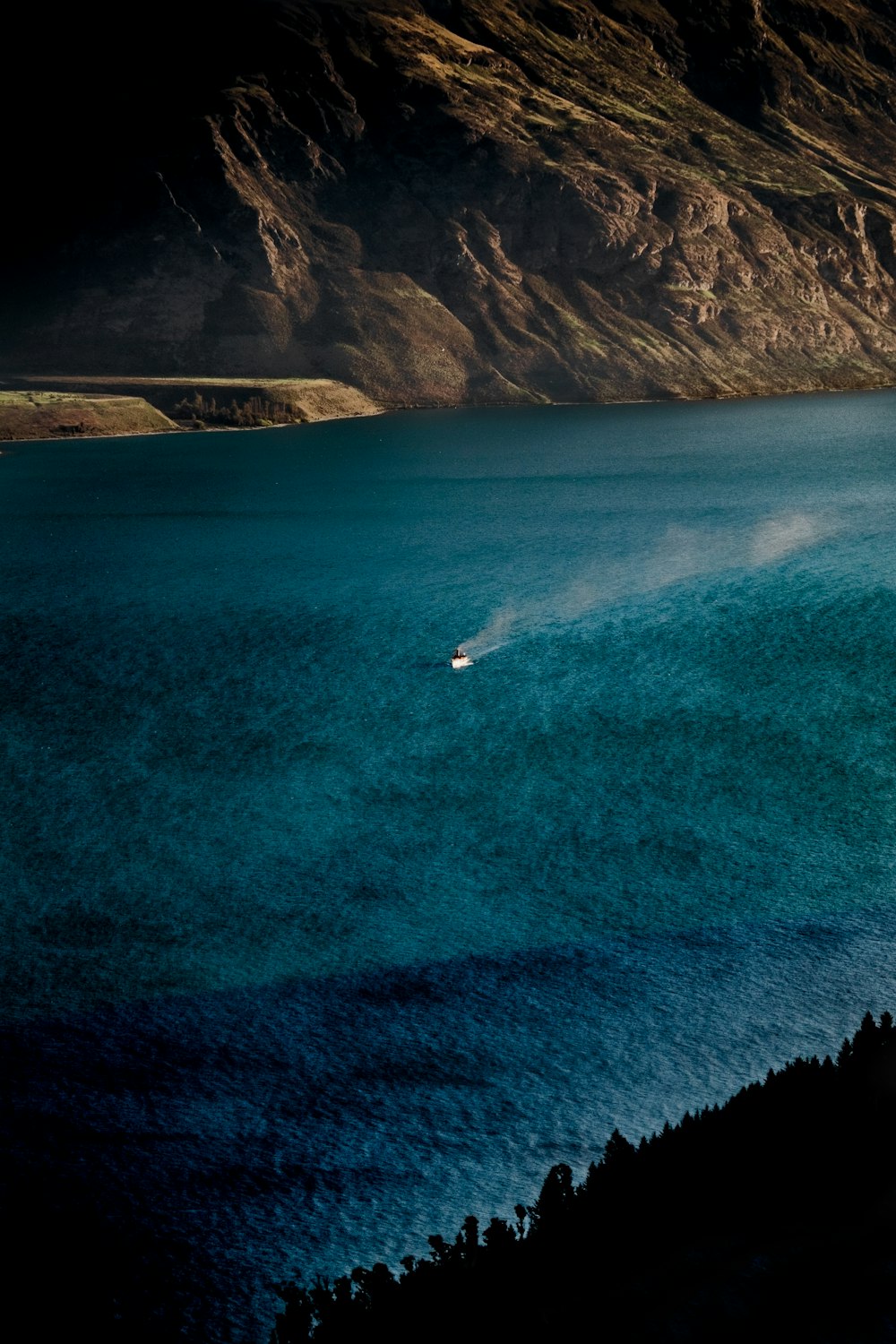 boat running on body of water during daytime