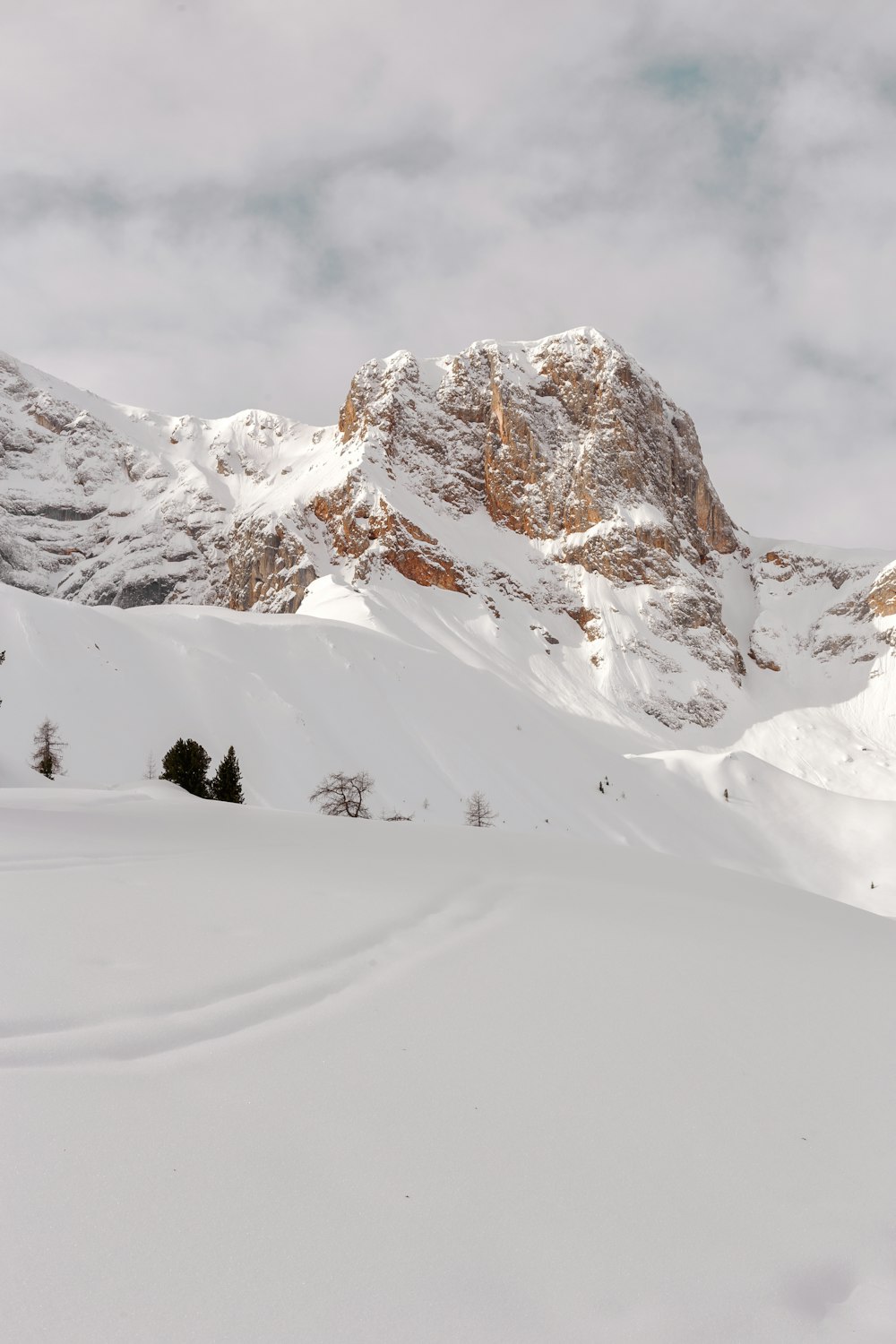 snow capped mountain under cloudy sky