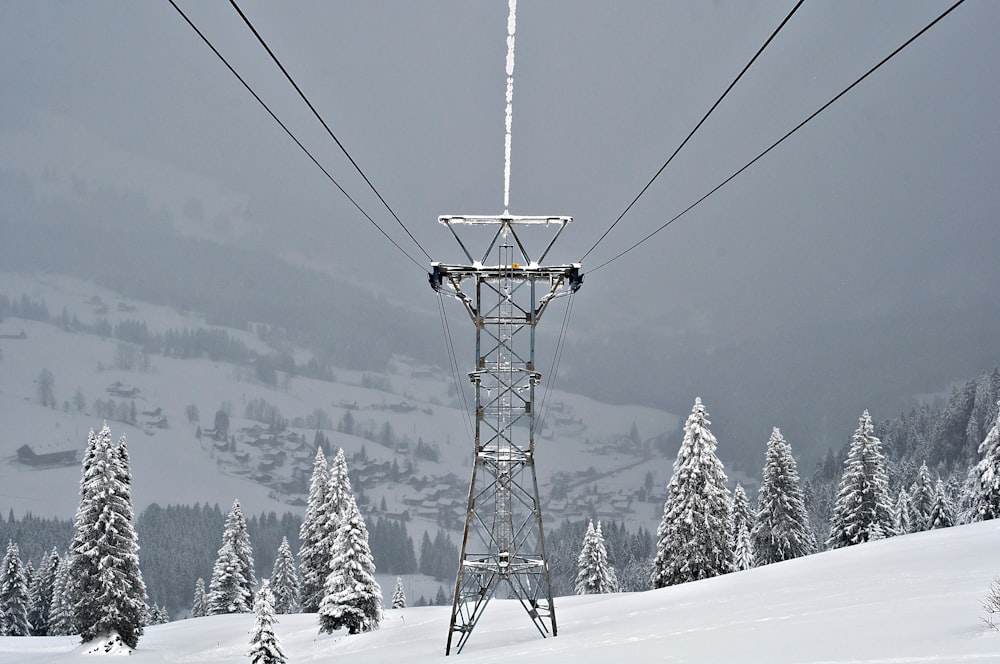 black metal transmission line covered with snow