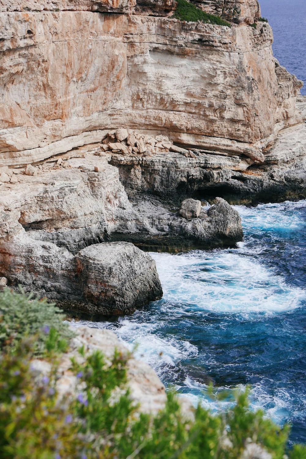 brown cliff beside body of water