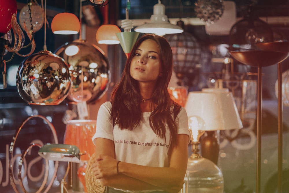 woman standing in front of assorted lamps