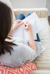 woman writing on white paper