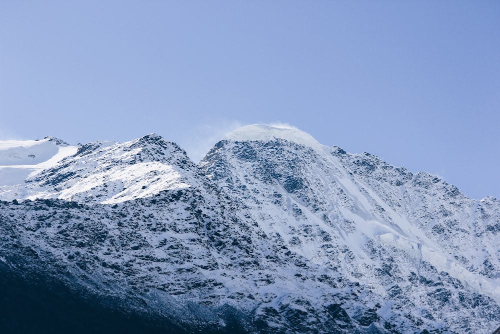 snow covered mountain under blue sky at daytime