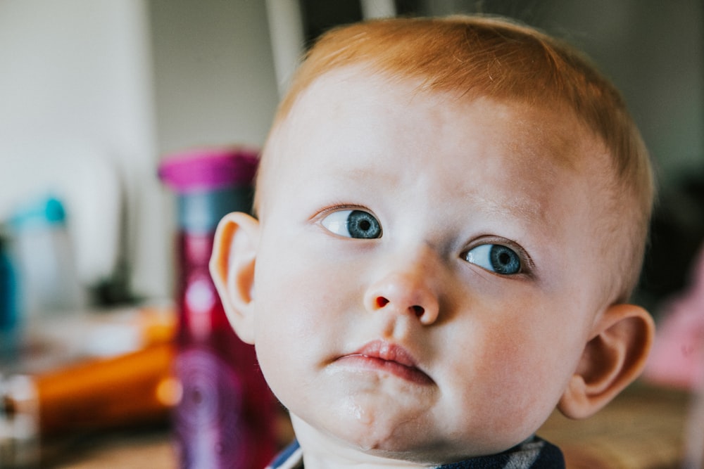 selective focus photography of child's face