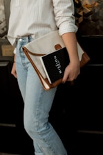 woman carrying white and brown leather bag
