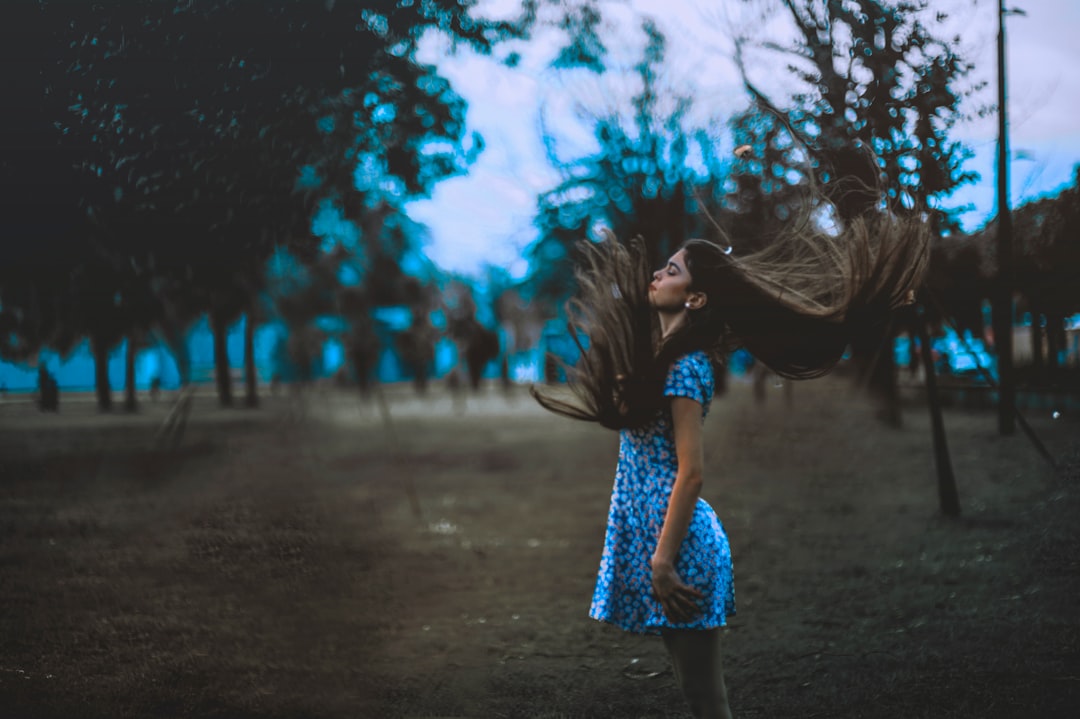 woman standing outside of plain field