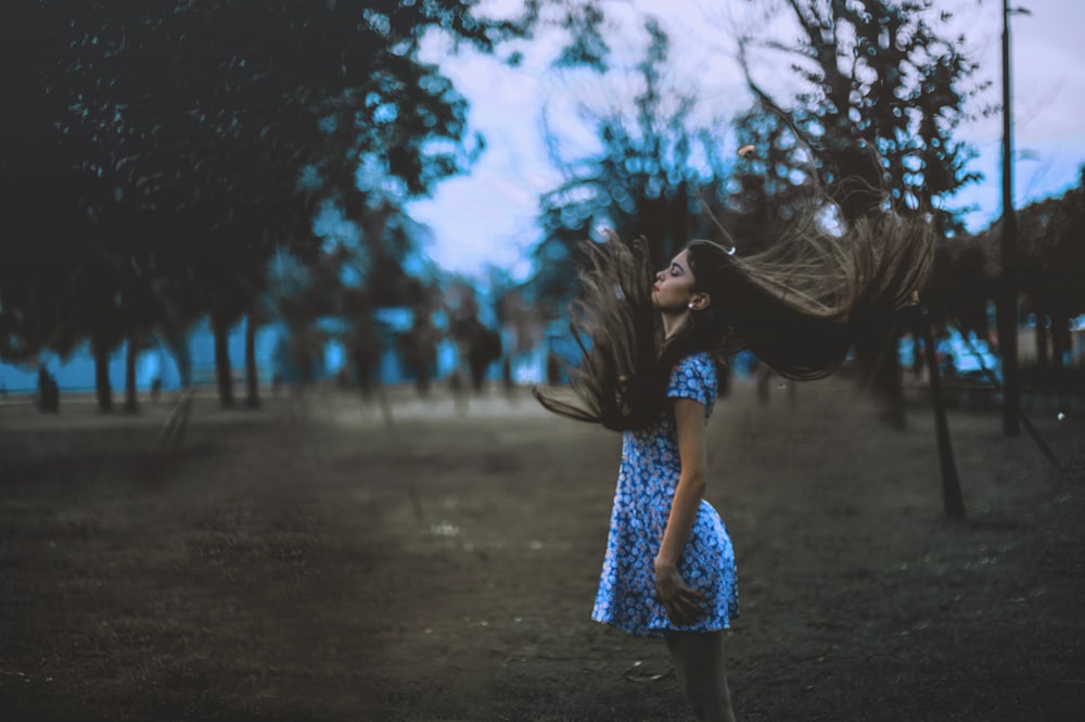 woman standing outside of plain field