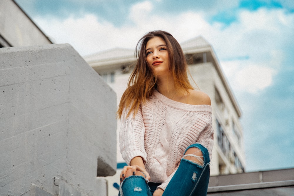 woman smiling and sitting on outdoor stair