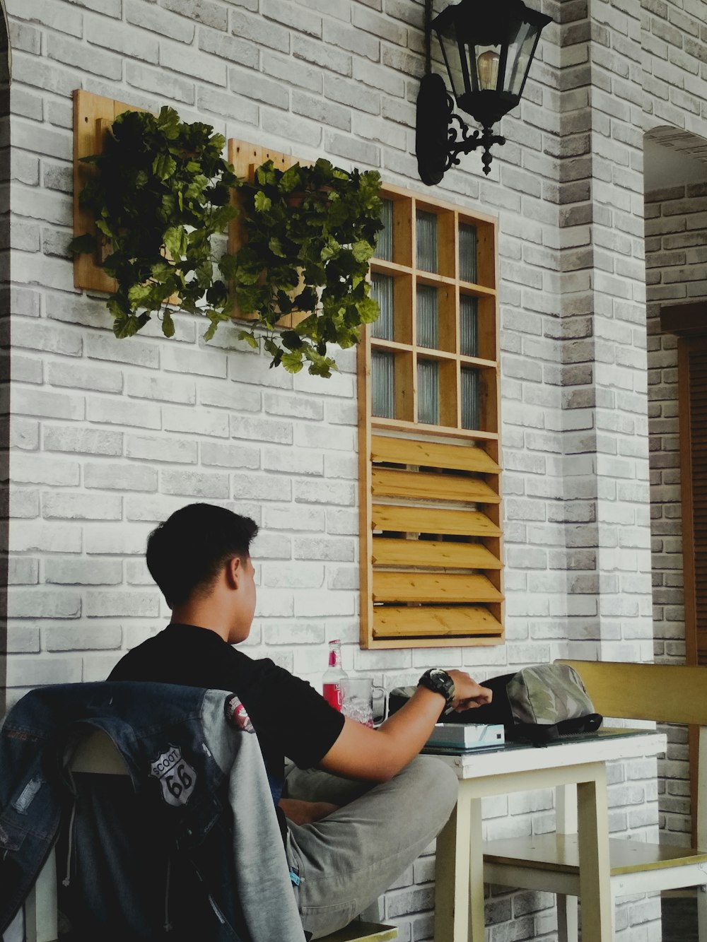 man sitting on white wooden chair