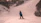 snowboarder standing on snow covered mountain