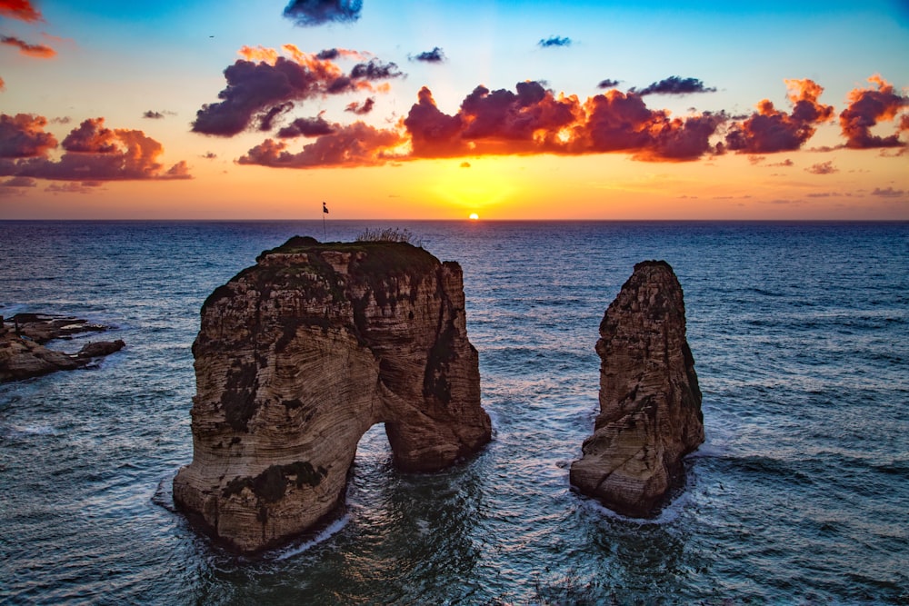 two rock formations in body of water