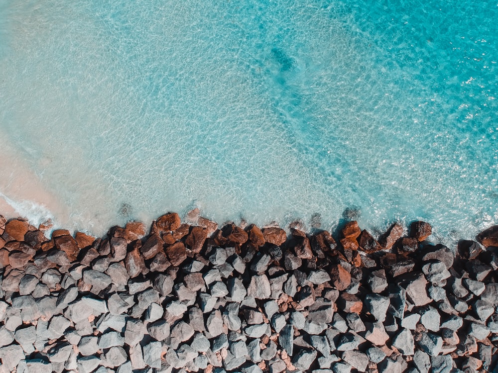 aerial view of rock formation beside body of water