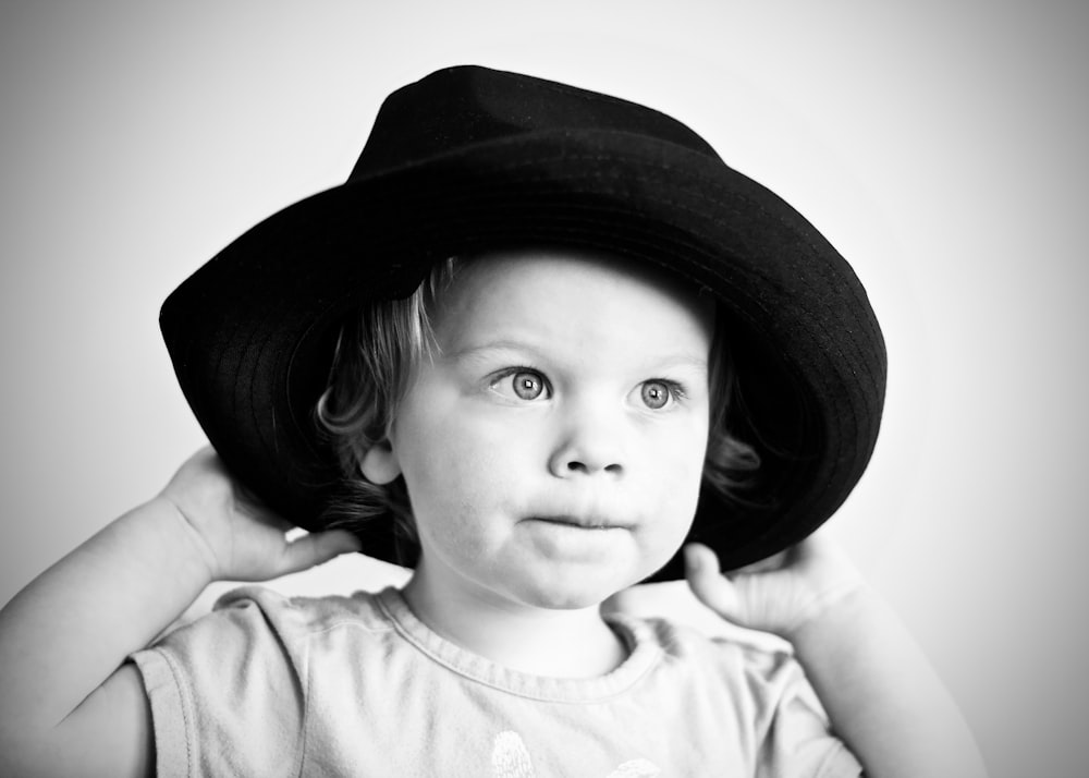 grayscale photography of girl with hat