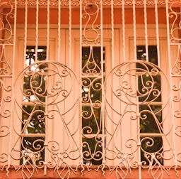 Close-up of a stylish invisible grill installed on a bright window, blending seamlessly with the exterior.