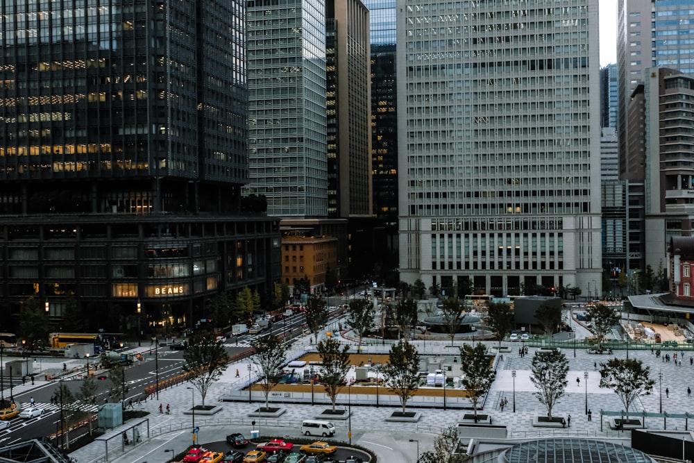 aerial view photography of people walking near high rise building during daytime