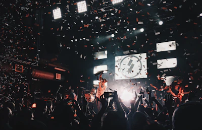 An energetic scene of a live event with artists and audience sharing a joyful moment.