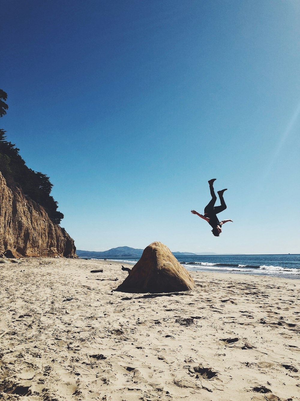 man back lifting on shore at daytime