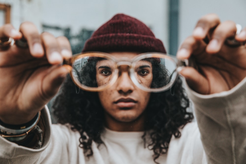 person holding eyeglasses