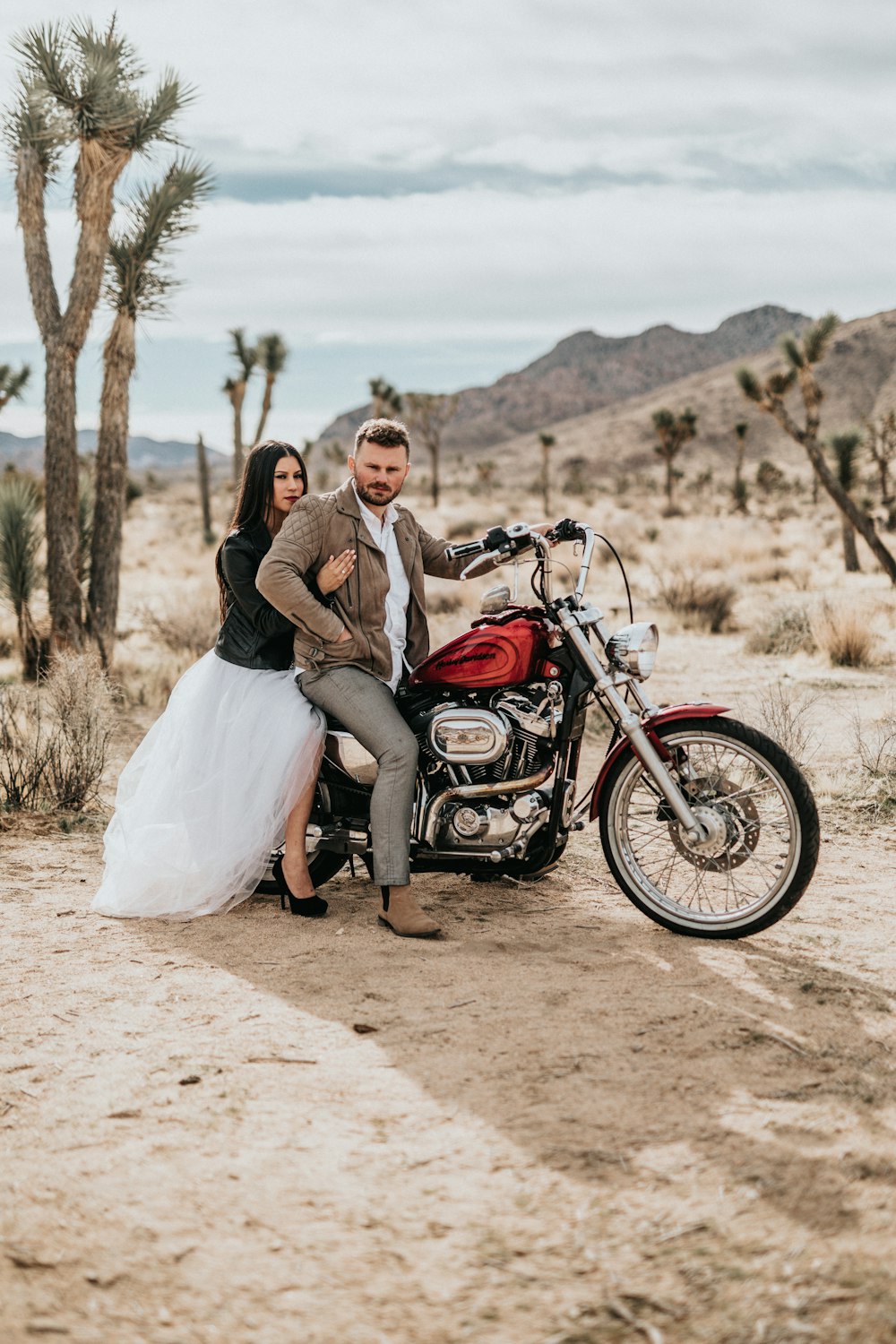 man and woman sitting on motorcycle