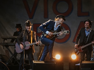 Energetic Roma folk band performing passionately on stage with traditional instruments.