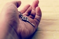 A close-up of a hand holding a golden key, representing new opportunities.